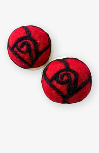 two felted wool dryer balls with needle felted red rose decoration