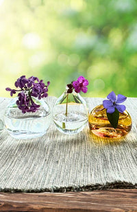 Small teardrop shaped glass bud vase. Handmade in Nepal. Fair trade.