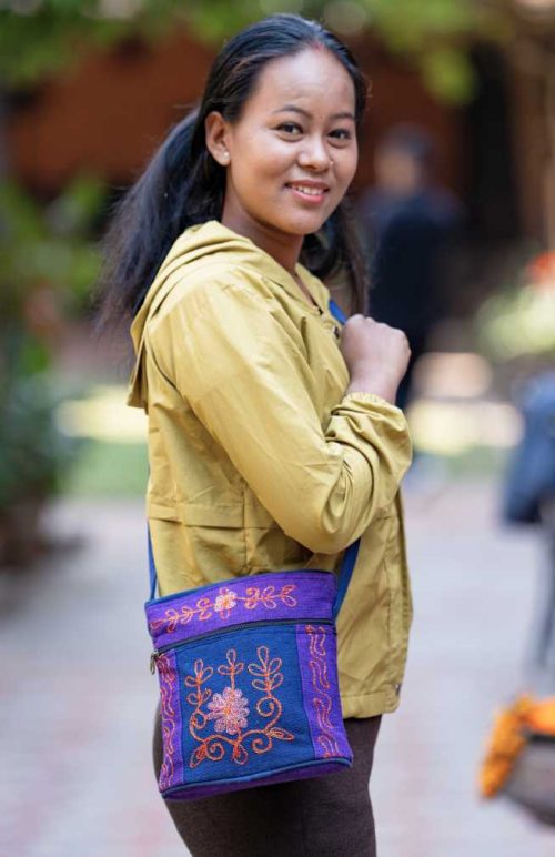 Oval bottom medium size purse with outside zipper pocket and embroidery