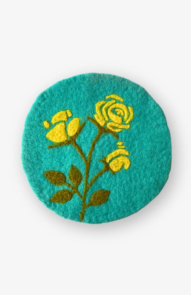 Felt flower of the month trivet, yellow rose on blue background