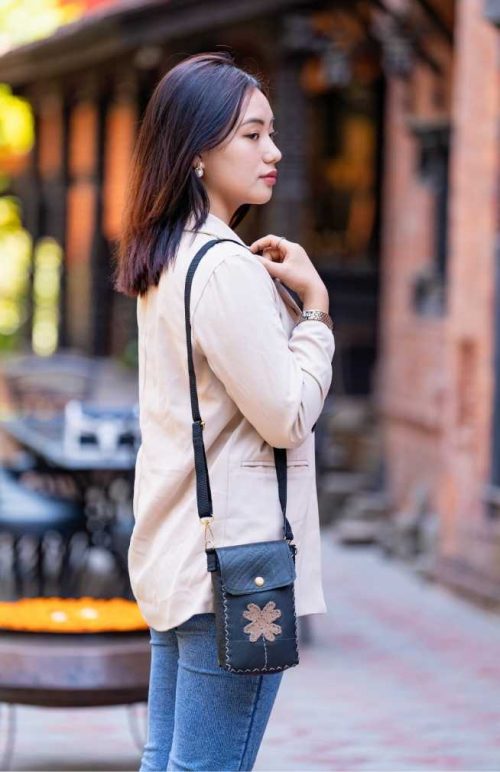 recycled rubber cross body bag with stitched leather flower