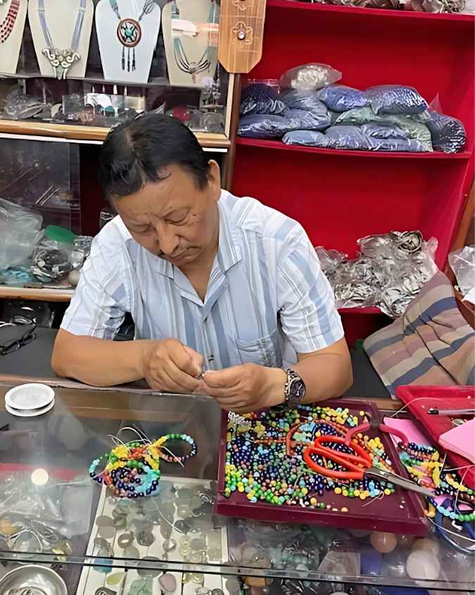 Tamding making chakra bracelets