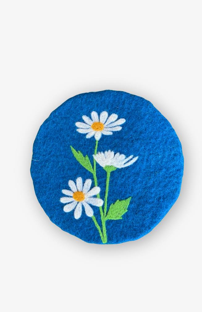 felt april flower of the month trivet daisy with blue background