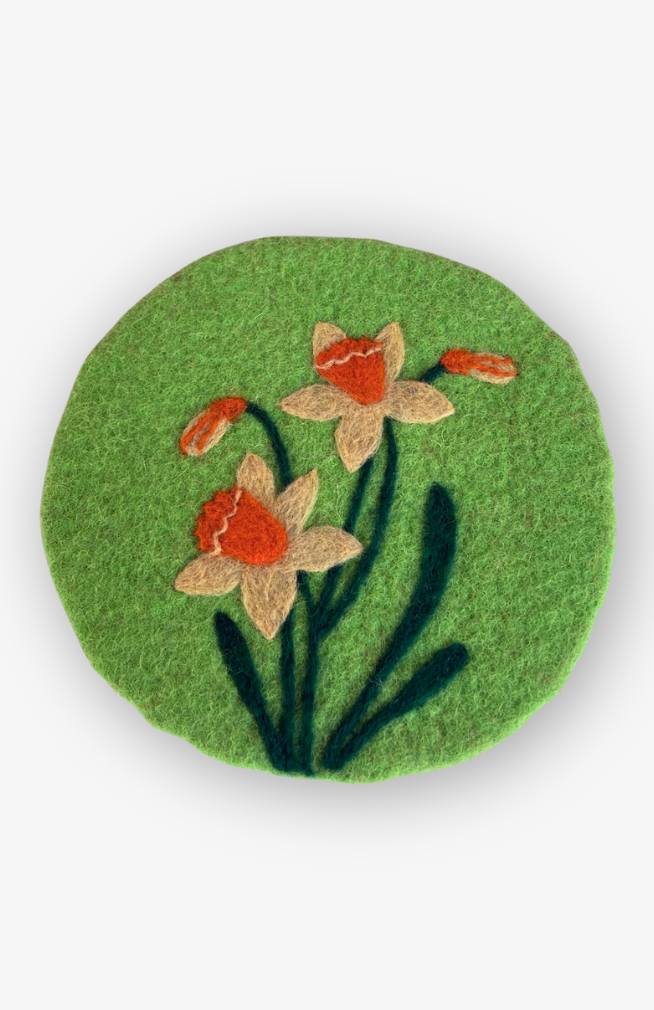 needle felted daffodil trivet with bright green background